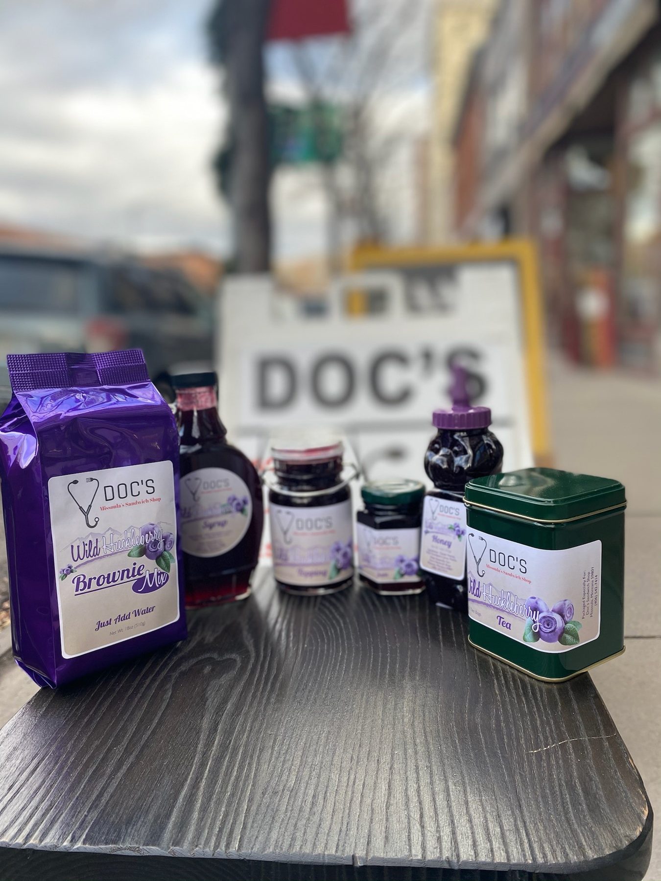 A sidewalk table outside Doc's set with the shop's jams and dressings